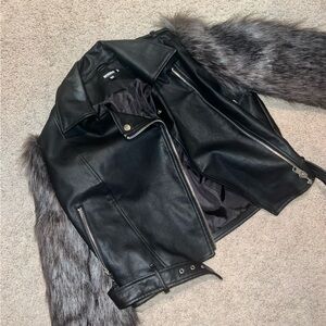 Us 10, fits like a medium. Black leather jacket with fur arms
